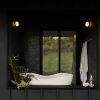 Outdoor bath with KOHLER Abrazo freestanding bath, KOHLER Stillness valve trim, Ann Sacks Savoy Mosaic tile, Andersen 100 series door, sill made of Richlite, Rich Brilliant Willing Crisp wall sconces, Boll & Branch organic towels and board and batten siding.